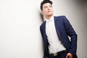 Canva - Man Wearing Blue Blazer and White Dress Shirt Leaning on White Wall